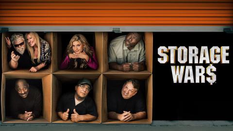 Cast members of 'Storage Wars' in cardboard boxes behind the door of a storage unit