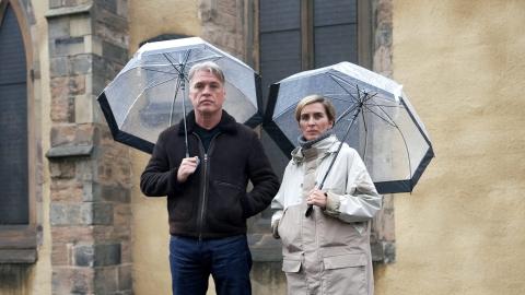 Vicky McClure and Jonny Owen standing together beneath umbrellas