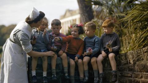 Five child evacuees speak with a nurse