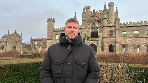 Rick Edwards stands in front of Lowther Castle