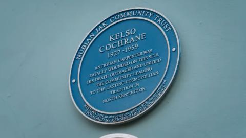 Blue plaque on a wall marking the location of Kelso Cochrane's murder