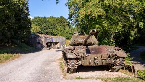 An old tank in front of a military fortification on the Maginot Line