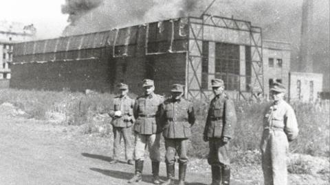German soldiers standing in front of the Ursus factory, where almost 6,000 residents were executed