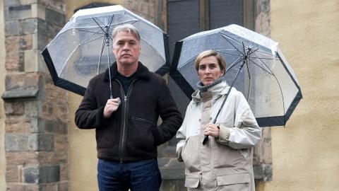 Vicky McClure and Jonny Owen standing together beneath umbrellas