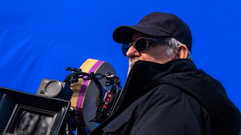 Steven Spielberg using a camera in front of a blue screen