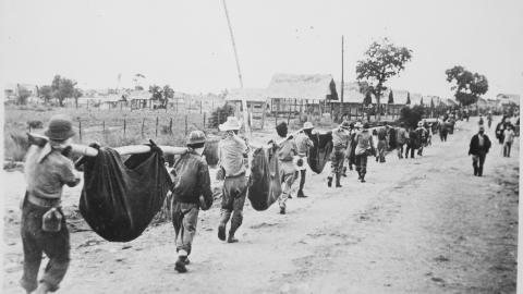 US prisoners using improvised litters to carry those of their comrades who died during the Bataan Death March