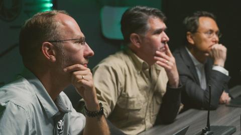Curse of Skinwalker Ranch team members inspecting a screen