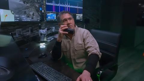 Erik Bard speaking into a walkie-talkie from a control centre