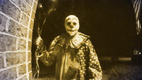 Doorbell footage of a creepy clown holding balloons