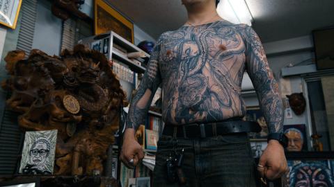 A Yakuza member covered in gang tattoos