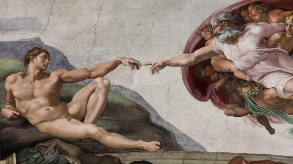 Photo of the ceiling of the SIstine chapel depicting Adam's creation