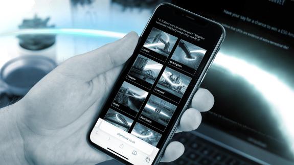 A mobile phone showing the Mystery Season survey on the screen