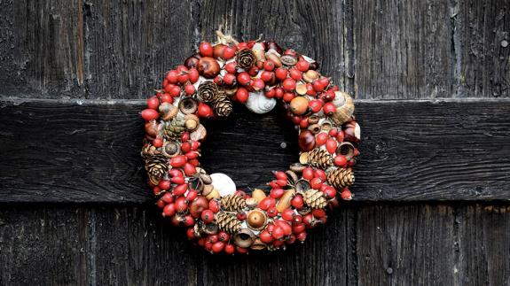 A red Christmas wreath on a wooden door
