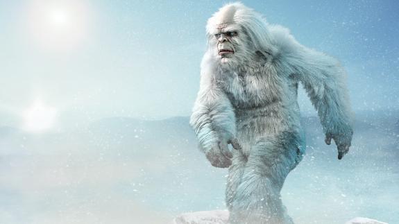 A Yeti strides across a snowy plain