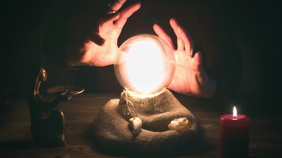 Crystal ball and fortune teller hands. Divination concept. The spiritual seance. Future reading.