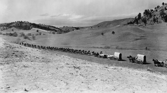 A massive wagon train moves through America's so-called Wild West