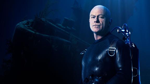 A graphic showing Ross Kemp alongside a shipwreck, for the new Sky HISTORY series 'Ross Kemp: Shipwreck Treasure Hunter'