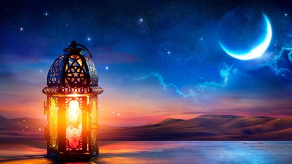 Muslim Holy Month Ramadan Kareem - Ornamental Arabic Lantern With Burning Candle Glowing At Evening