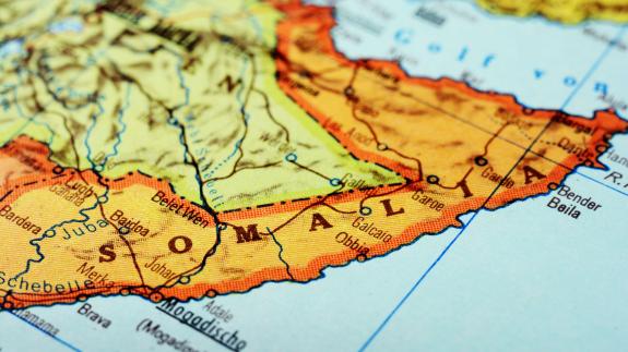 Close-up of a red pushpin on a map of Mogadishu, Somalia Africa - travel concept