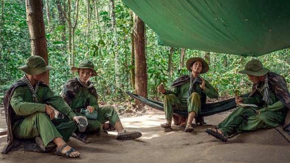 Soldiers sitting under a canopy. Installation of the American Vietnam war near the ku Chi tunnels. 15 November 2017. Ho Chi Minh City, Vietnam
