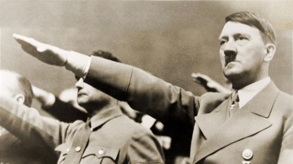 Adolf Hitler in 1939, giving Nazi salute. To Hitler's right is Rudolph Hess.