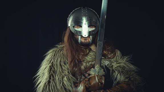 A Viking warrior holding a sword and wearing a fur skin - meant to represent Ivar the Boneless