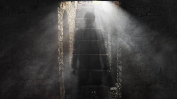 A ghostly figure in a gloomy dungeon