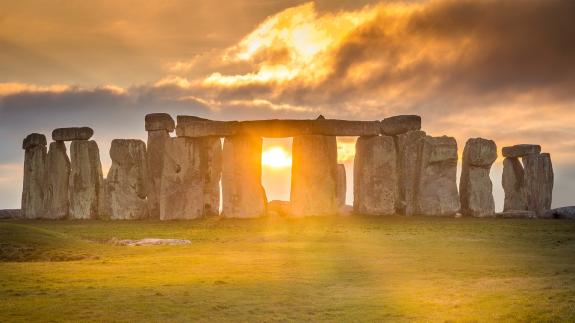 The Sun shining through the stones of Stonehenge