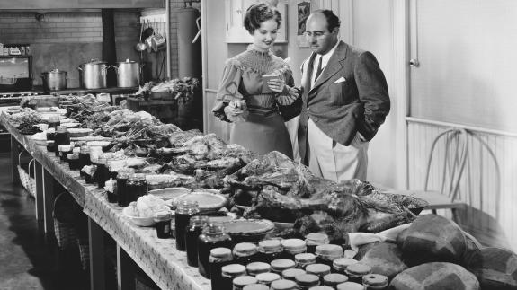 A couple surveying a table of food
