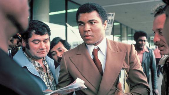 Muhammad Ali signs autographs for fans at the San Antonio International Airport in 1979