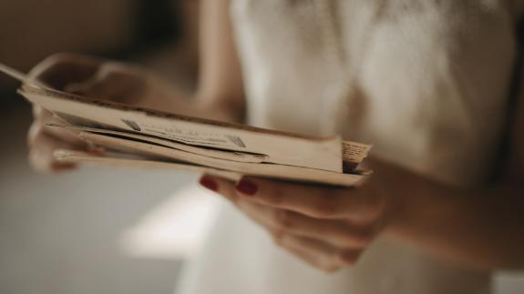 A woman holding old letters