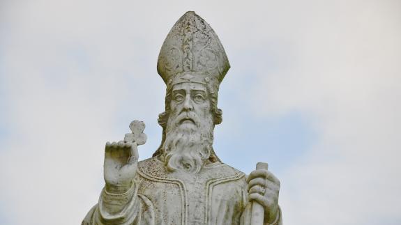 Statue of St Patrick holding a shamrock