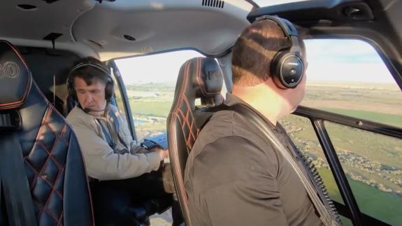 Two members of the Skinwalker Ranch team in a helicopter