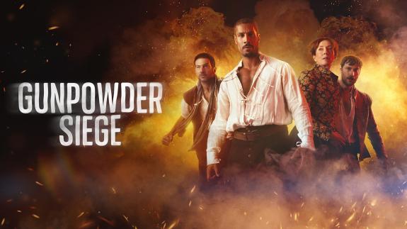 'GUNPOWDER SIEGE' - actors standing in front of an explosion