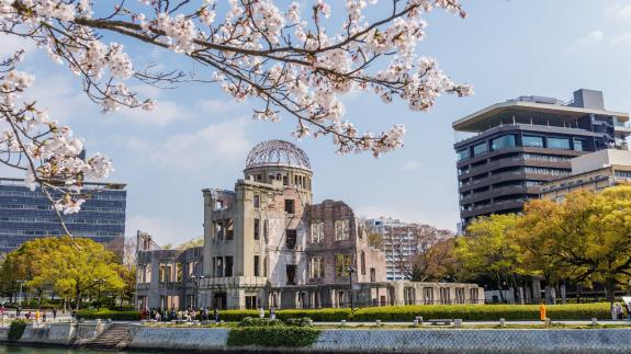 The Hiroshima Peace Memorial in the 21st century with cherry blossoms in the foreground