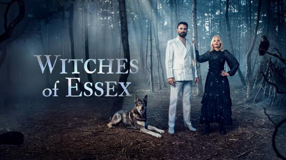 Rylan Clark and Professor Alice Roberts stand in a forest next to a wolf and a crow