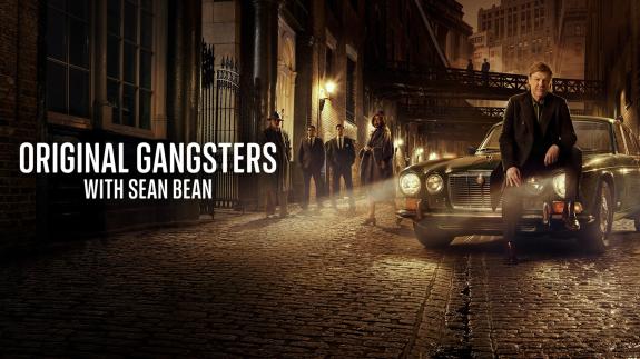 Sean Bean sits on a classic car in a dimly lit street beside retro gangsters and the text 'Original Gangsters with Sean Bean.'
