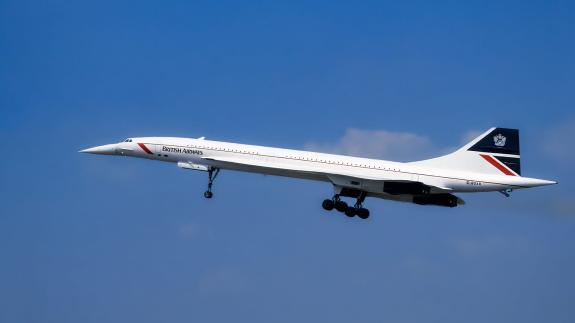 A Concorde plane belonging to British Airways taking off against a blue sky