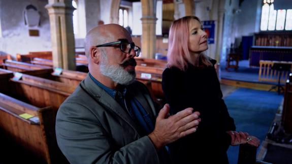 Tony McMahon and Professor Alice Roberts talking inside a church