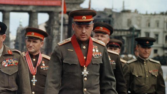 Georgy Zhukov wearing a medal in front of the Brandenburg Gate in Berlin