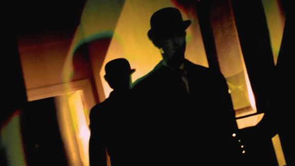 Silhouette of two men in bowler hats 