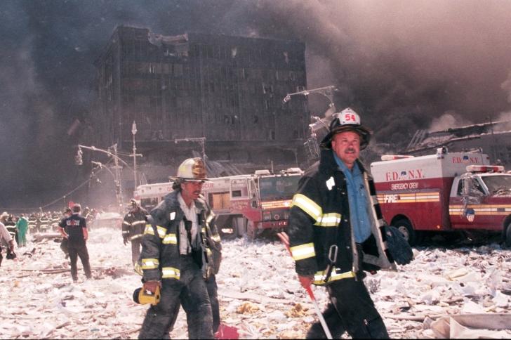 New York City firefighters walk near the area known as Ground Zero after the collapse of the Twin Towers