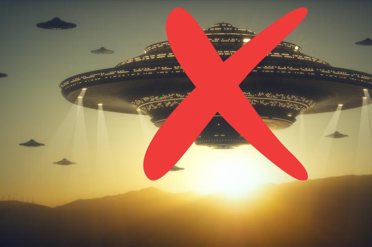 Large UFOs hover above mountains at sunset with a big red X drawn over the scene.