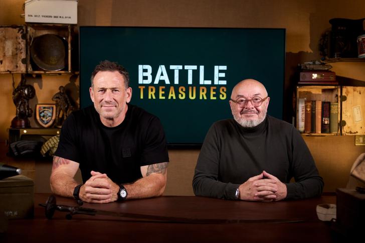 Jason Fox and Bruce Crompton sitting in front of the words 'Battle Treasures' on a television screen