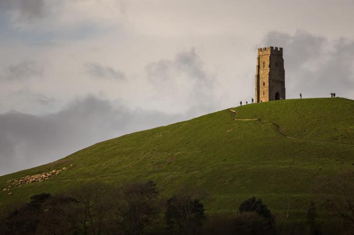 Hikers at Glastonbury Tor on top of the hill