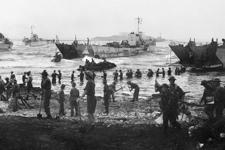 Troops from 51st Highland Division unloading stores from tank landing craft on the opening day of the Allied invasion of Sicily, 10 July 1943