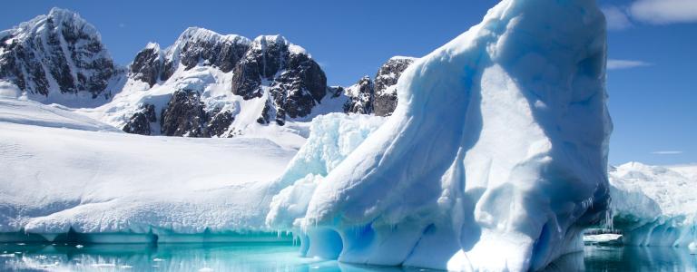 A large ice formation floating on the coast of Antarctica