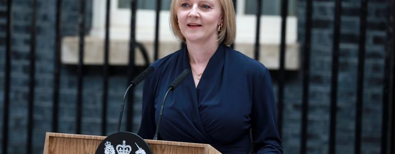 Prime Minister Liz Truss stands at a podium outside Downing St