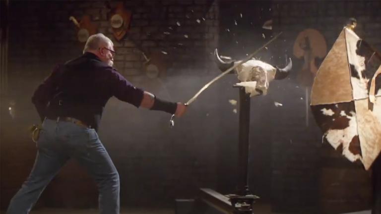 David Baker shatters a cattle skull with a large sword