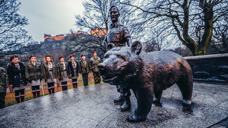 Polish scouts stand next to a Wojtek the Soldier Bear memorial in Edinburgh in 2015